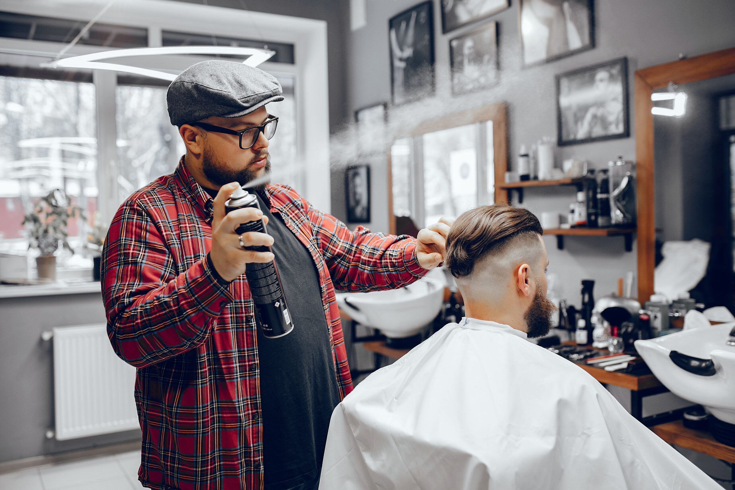 Man with a beard. Hairdresser with a client. Man in a red shirt