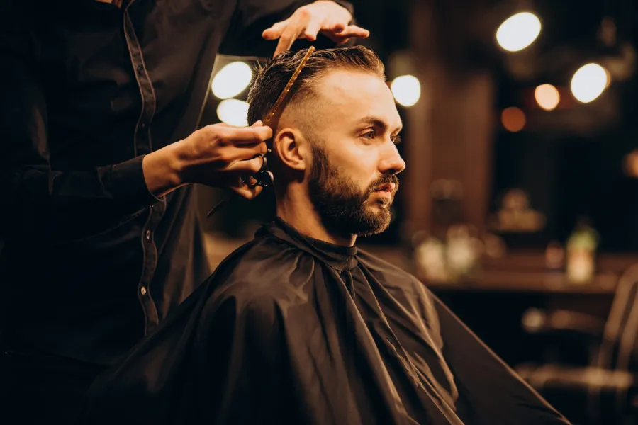 Barber detailing a client's fade